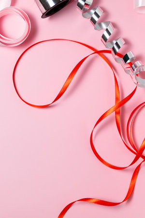 Close-up of ribbon for wrapping gifts on a pink background, gift wrapping, holidaysの写真素材