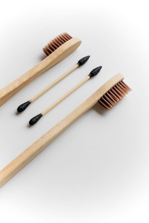 Biodegradable ear sticks and toothbrushes on a white backgroundの写真素材