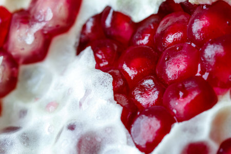 Pomegranate and pomegranate seeds macro photo lightの写真素材
