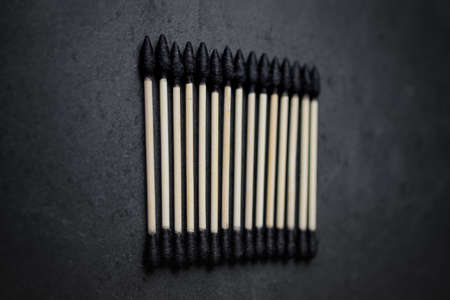 Biodegradable ear sticks on a white and black backgroundの写真素材