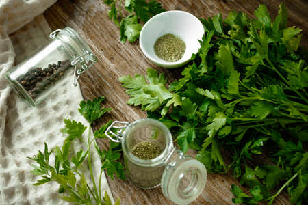 Fresh parsley and spices on a wooden boardの写真素材