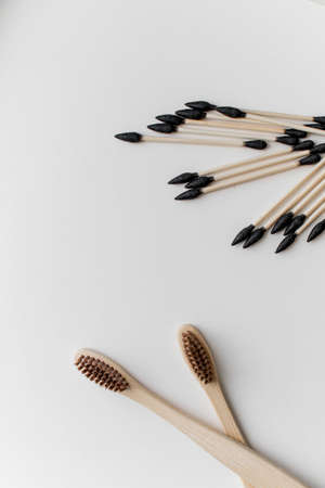 Biodegradable ear sticks and toothbrushes on a white backgroundの写真素材