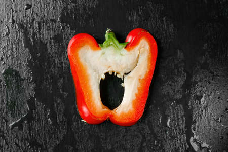 red juicy peppers on a dark backgroundの写真素材