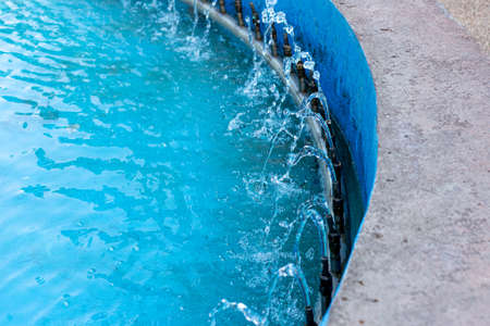 Water flows from pipes with a fountain of blue color, water splashes from the fountainの写真素材
