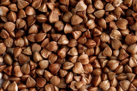 Macro photo of buckwheat groats. Many small objects close up. Healthly foodの写真素材