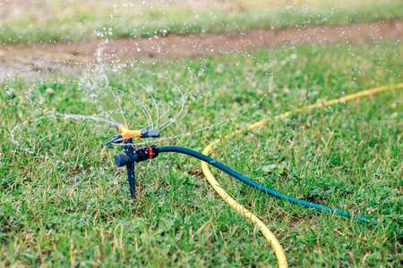 Close up of lawn irrigation. Automatic sprinkler system watering the lawn close-up.の写真素材