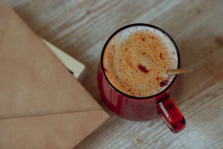 Coffee in a glass cup and morning mail stand on a wooden table.の写真素材