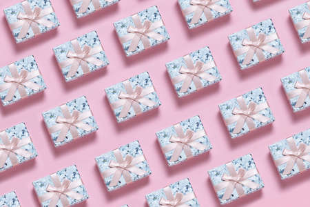 Small gift box with pink ribbon bow on pink background, pattern, backgroundの写真素材