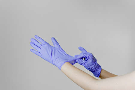 Girl and medical gloves on a white background. High quality photo