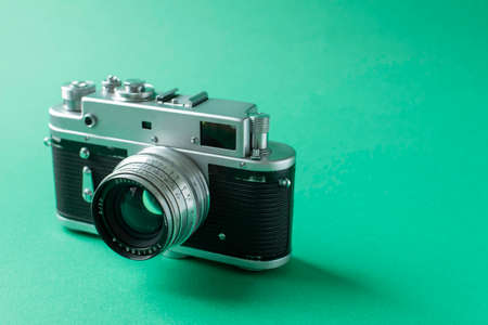 Retro film camera on green background. High quality photoの写真素材