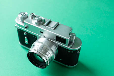 Retro film camera on green background. High quality photoの写真素材