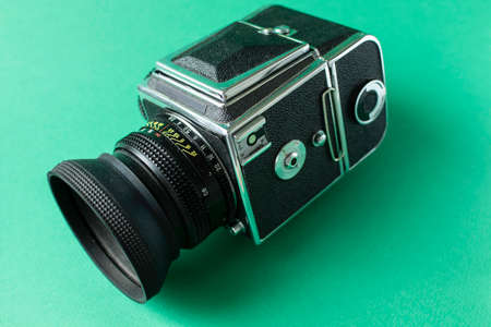 Retro film camera on green background. High quality photo