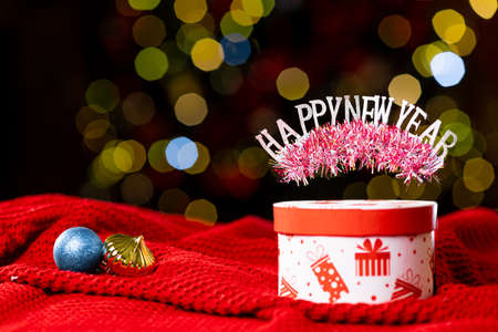 Festive christmas box on bokeh background and inscription happy new year. High quality photoの写真素材