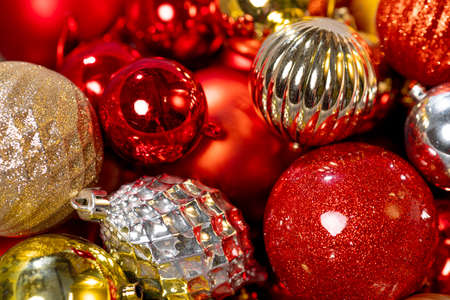 Lots of red and gold Christmas tree decorations in a box. Preparing for the new year, decor for the New Year tree. High quality photoの写真素材