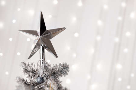 Star on top of christmas white tree, bokeh background. High quality photoの写真素材