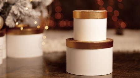 Gift boxes near the christmas tree on a bokeh background, new year holidays. High quality photoの写真素材