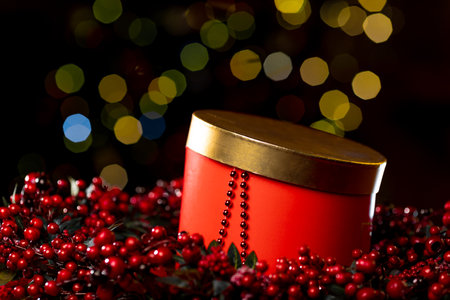 Christmas red box and decorations on the Christmas tree on a dark background with bokeh. High quality photoの写真素材