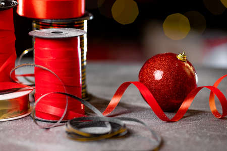 Christmas shiny ball for christmas tree and red ribbon for giftsの写真素材