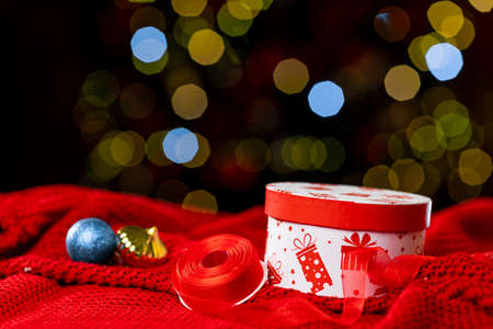 Christmas gift boxes, packing tape and balls on bokeh background, new year attributesの写真素材