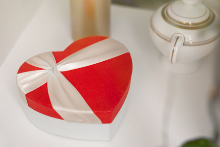 A gift box in the form of a red heart is on a shelf. Valentines Day - February 14の写真素材