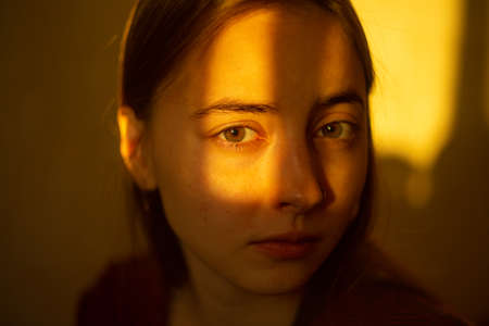 Close-up portrait of a two-legged woman with sunlight on her face. high quality photo