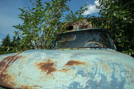 Old abandoned rusty car in the village. high quality photoの写真素材