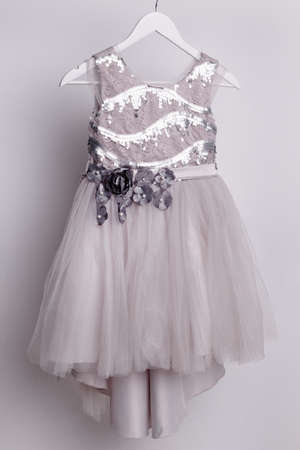 Dress for a girl - festive outfit on a hanger, ball gown for children. high quality photoの写真素材