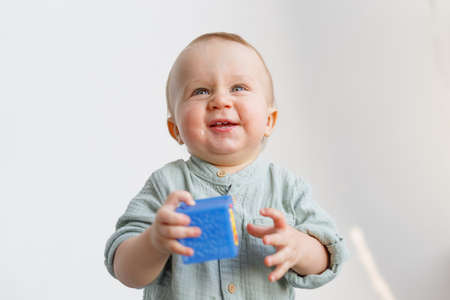 One-year-old baby plays with cubes in the apartment. high quality photoの写真素材