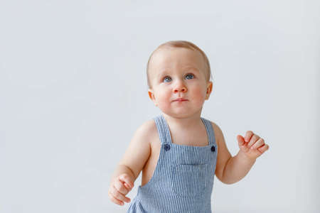 Portrait of a baby with blue eyes on a light background, white background for advertisingの写真素材