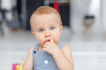 Portrait of a baby with blue eyes on a light background, white background for advertisingの写真素材
