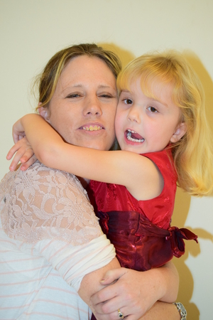 Young Girl having Cuddles with mumの写真素材