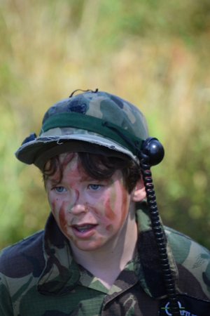 Young Boy playing laser tag while dressed in army style overallsの写真素材