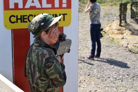 Young Boy playing laser tag while dressed in army style overallsの写真素材