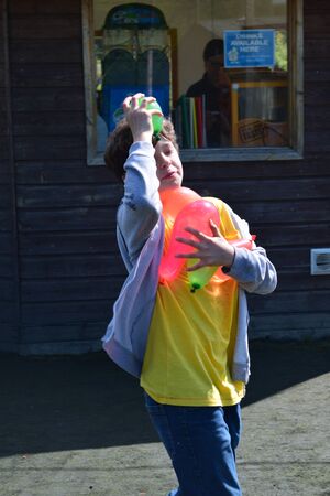 Young boys Have water fight with water bombsのeditorial素材