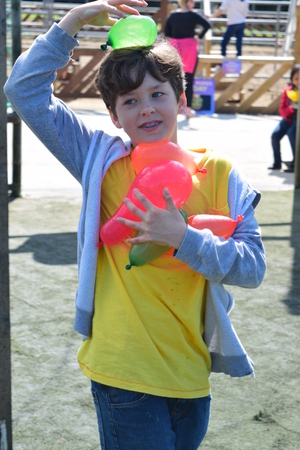 Young boys Have water fight with water bombsの写真素材