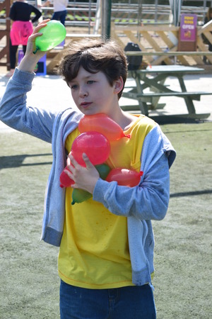 Young boys Have water fight with water bombsの写真素材