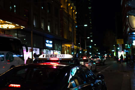 A taxi sign with blurry city light in the backgroundのeditorial素材