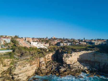 Aerial view of rock cliff and residential area around it.の写真素材