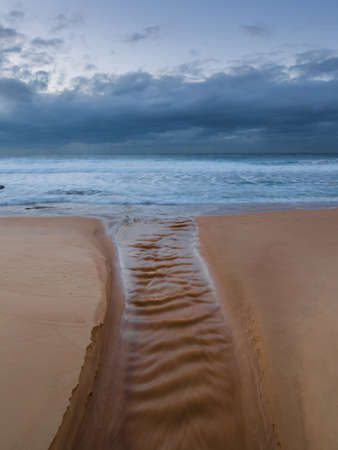 A water stream view leading into the ocean.の写真素材
