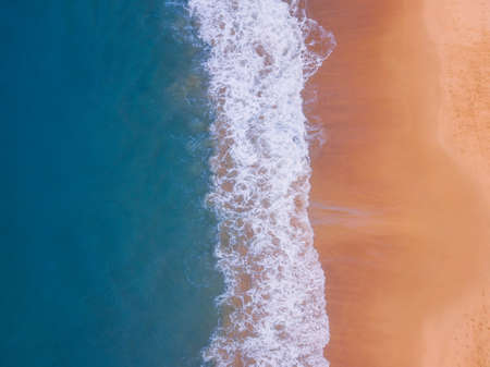 Aerial view of empty beach with blue water coastline.の写真素材