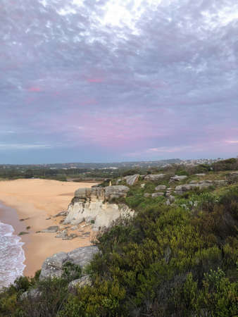 Purple sky above the cliff at sunrise time.