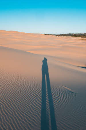 Long shadow of a person in the desert.の写真素材