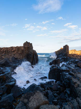 Rough water on small channel between rocks at Bombo Quarry, NSW.の写真素材
