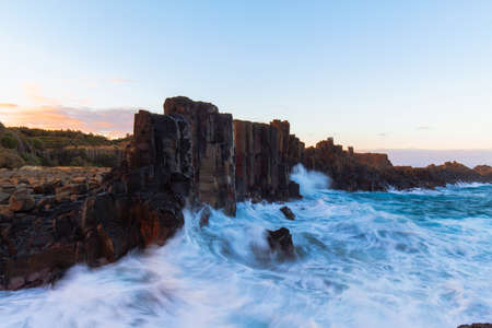 Water crashing into Bombo Quarry rock formation.の写真素材