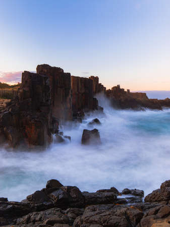 Long exposure of water crashing into Bombo Quarry rock formation.の写真素材