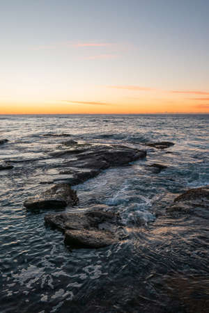 Sea water along coastline rocks.の写真素材