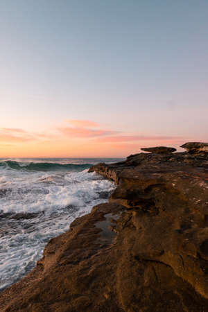 Morning light at the rock cliff along the coastline.の写真素材