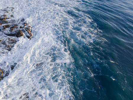 Aerial view of wave and its breaking foam.