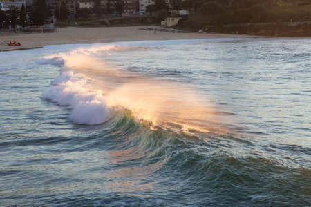 Wave breaking at Coogee Beach with water spray around.の写真素材