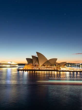 Sydney, Australia - July 19, 2018: Light trail of ferry passing through Sydney Opera House at dawn.のeditorial素材
